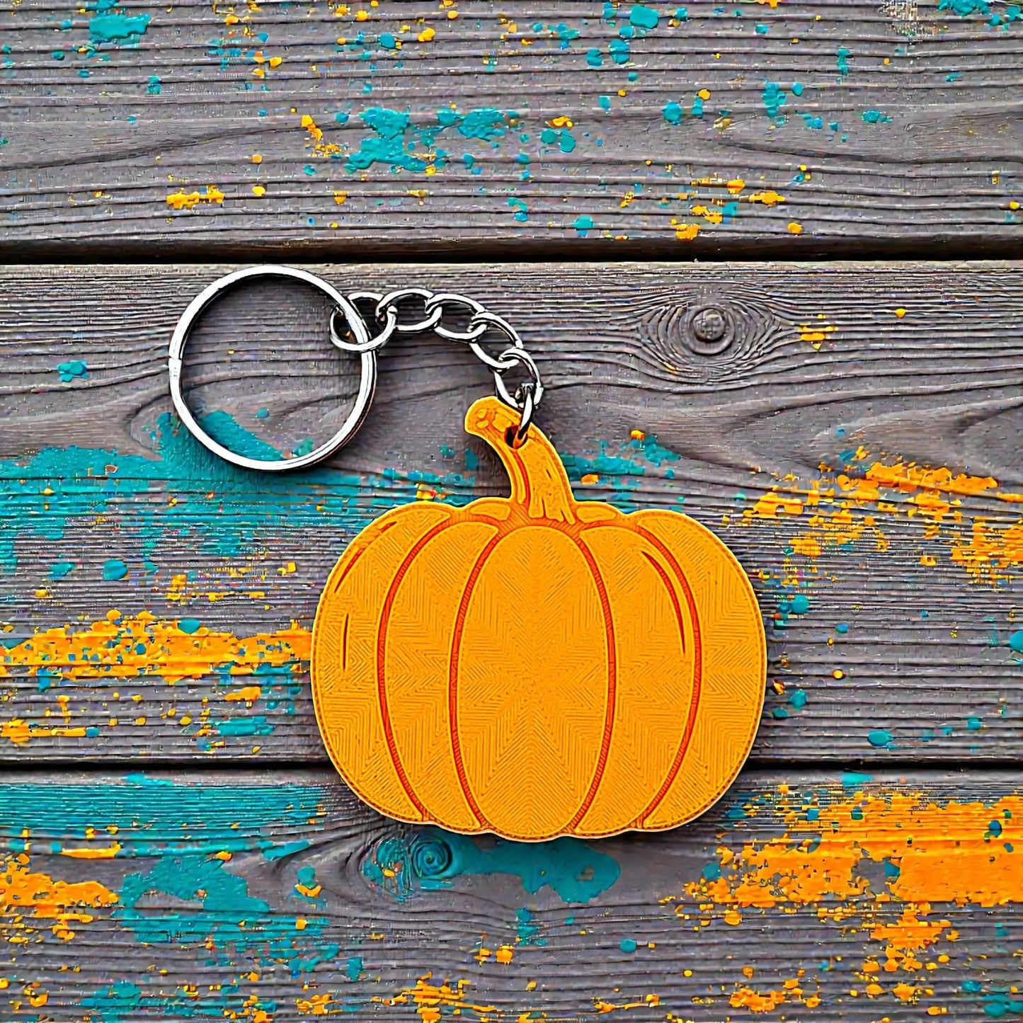 Handmade and customizable pumpkin keychain in pumpkin orange, ideal for fall themed party favors, cute bag charms, and classroom prizes.