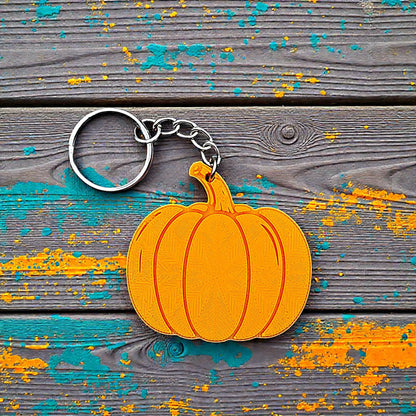 Handmade and customizable pumpkin keychain in pumpkin orange, ideal for fall themed party favors, cute bag charms, and classroom prizes.