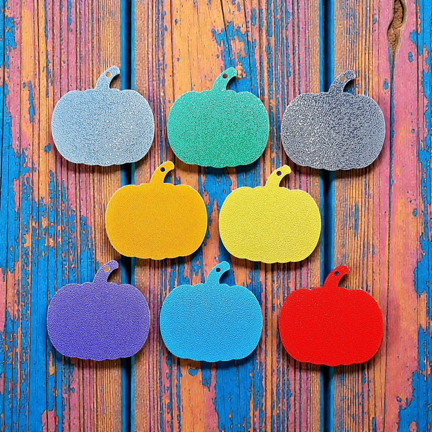 Reverse of handmade and customizable pumpkin keychains in various colors, ideal for fall themed party favors, cute bag charms, and classroom prizes.