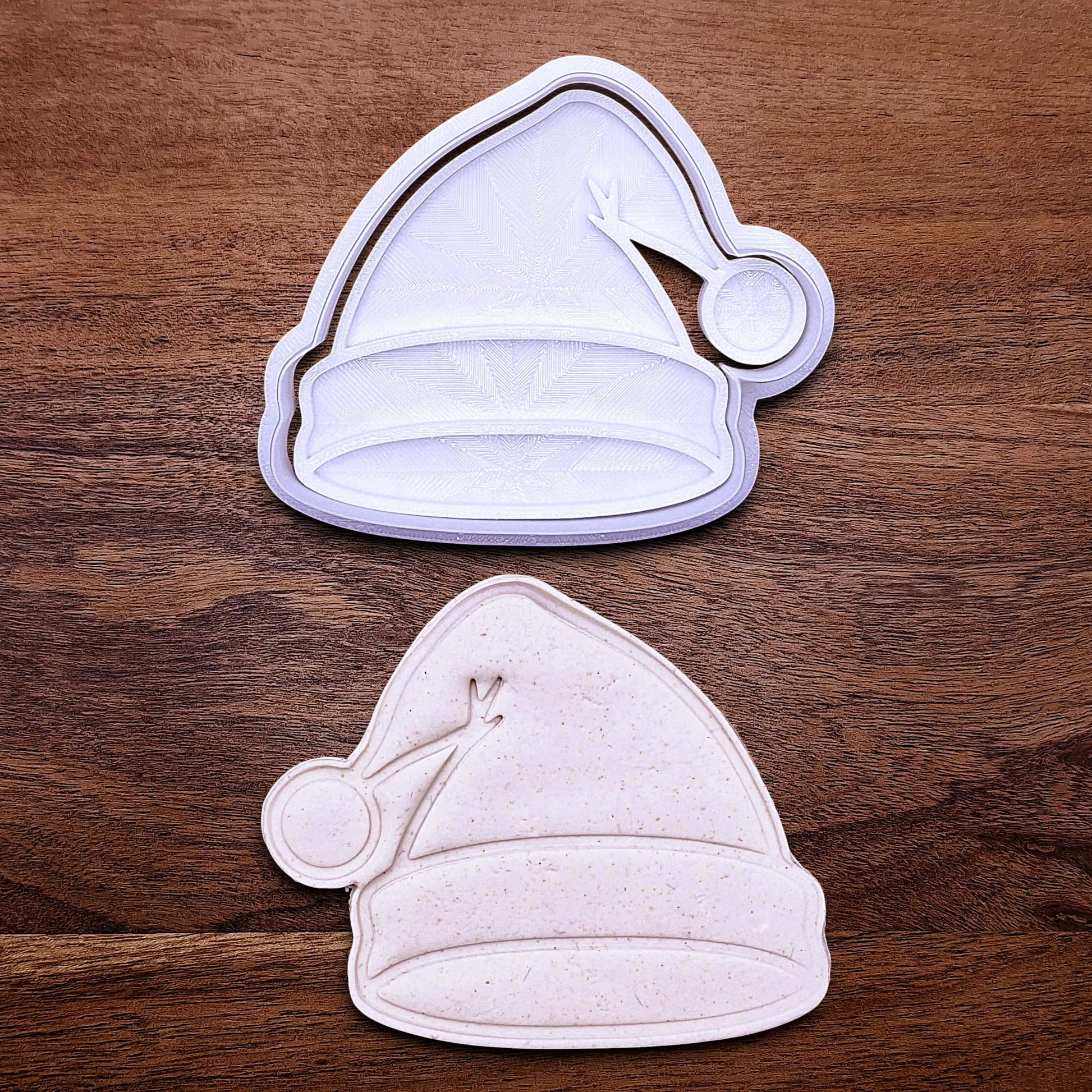 Santa hat cookie cutter and stamp and dough cutout and imprint, perfect for Christmas cookies, festive fondant toppers, or Xmas holiday crafts.