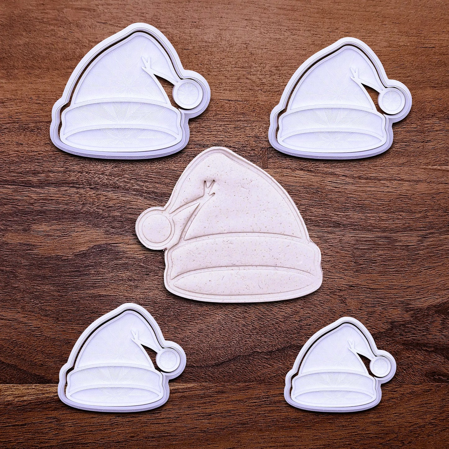 Santa hat cookie cutter and stamp set in multiple sizes and dough cutout and imprint, perfect for Christmas cookies, festive fondant toppers, or Xmas holiday crafts.