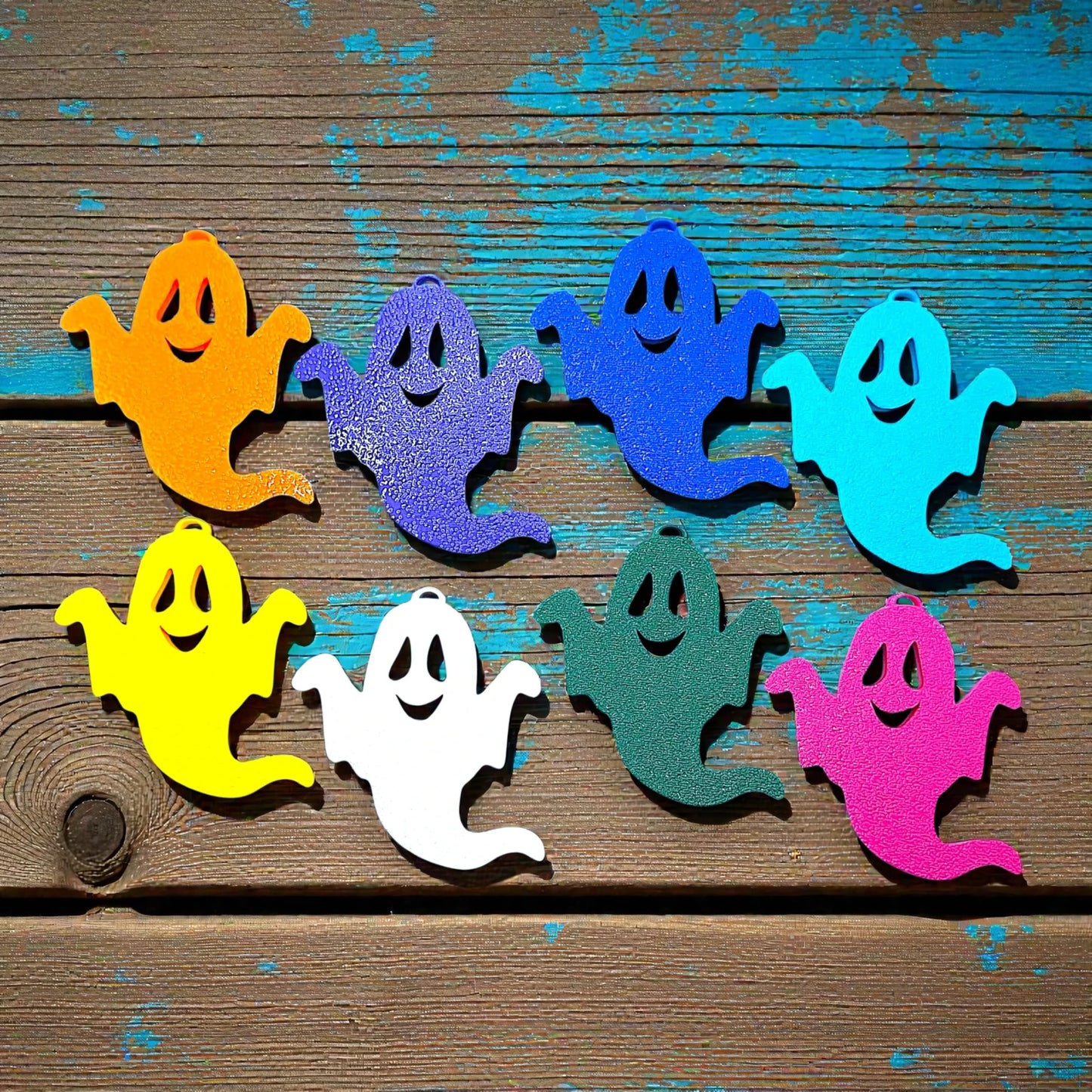 Eight handmade spooky Halloween ghost keychains in customizable colors, ideal for fall party favors, gifting, or accessorizing Halloween-themed trick or treat bags or keys.