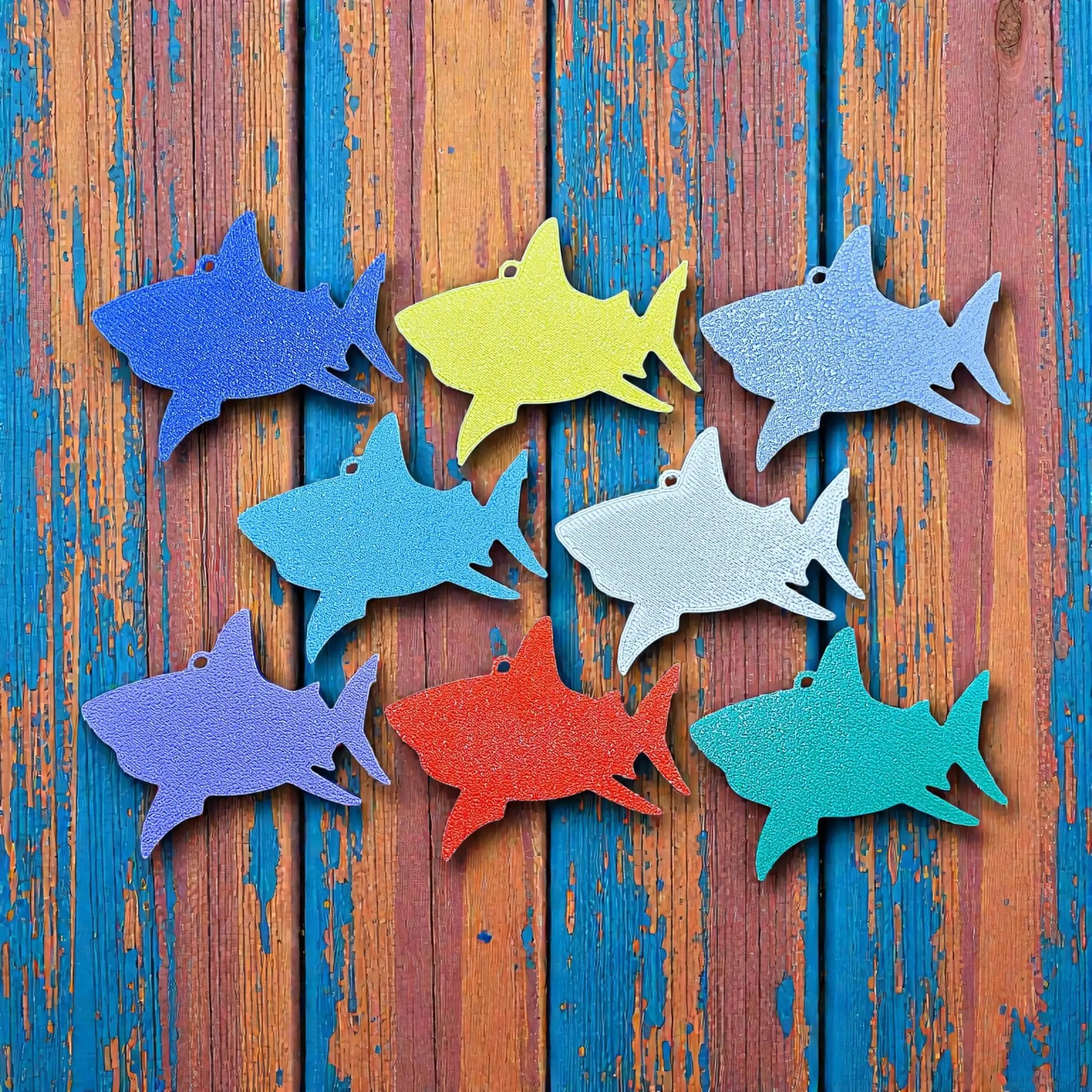 Reverse of handmade and customizable shark keychains in various colors, perfect for under-the-sea party favors, bag charms, and cool classroom prizes.