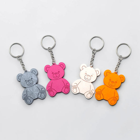 Colorful teddy bear keychains in various colors - handmade eco-friendly charms perfect for kids, baby showers, party favors, or animal-themed gifts.