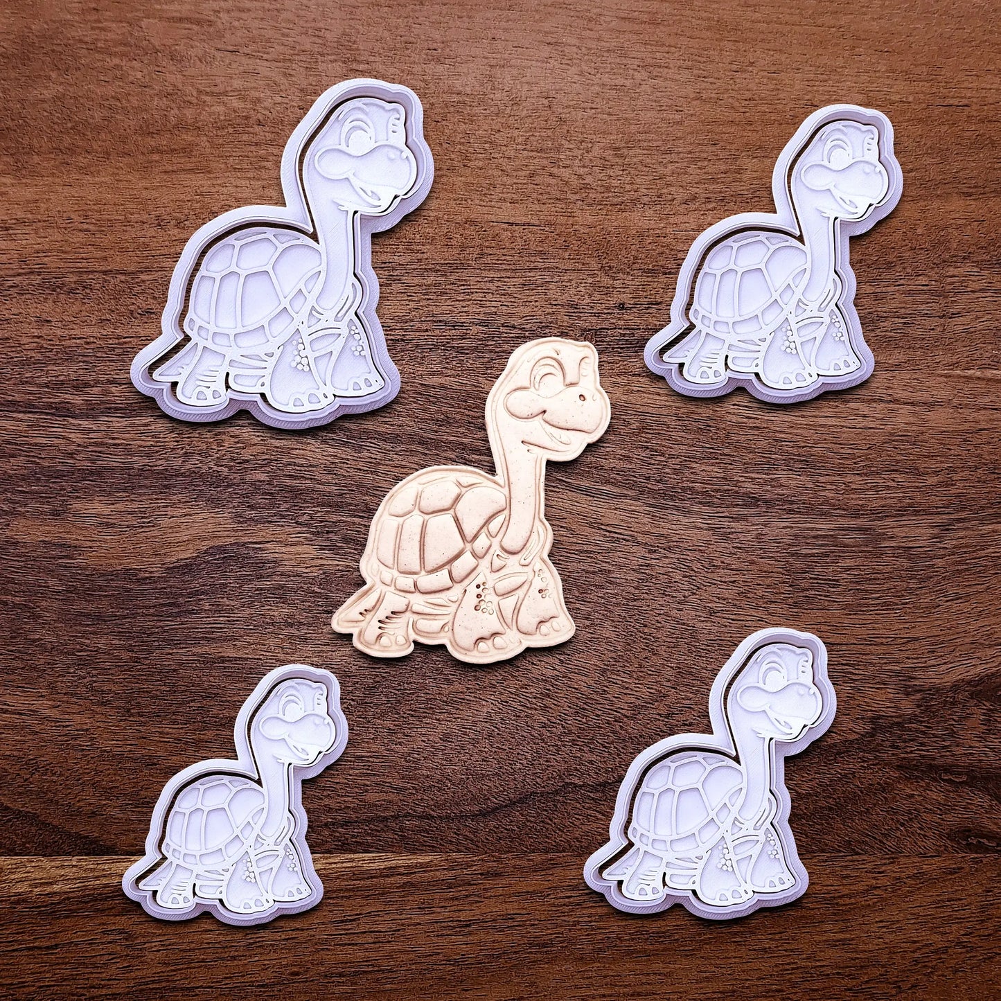 Handmade and customizable turtle cookie cutters and stamps alongside a dough imprint, ideal for ocean-themed baking, birthday party treats, or handmade gift ideas.