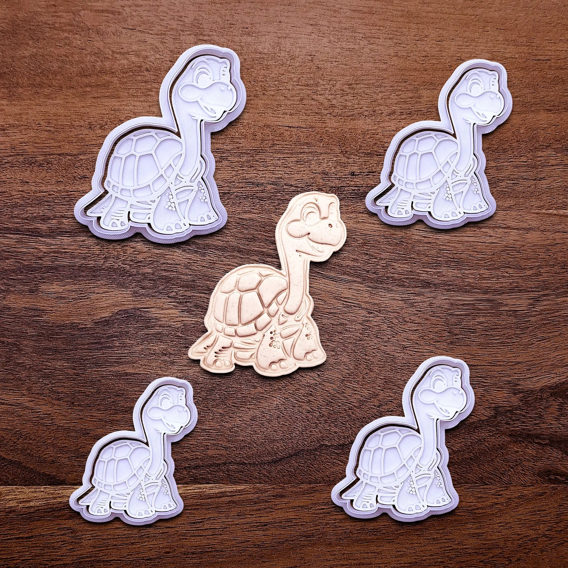 Handmade and customizable turtle cookie cutters and stamps alongside a dough imprint, ideal for ocean-themed baking, birthday party treats, or handmade gift ideas.