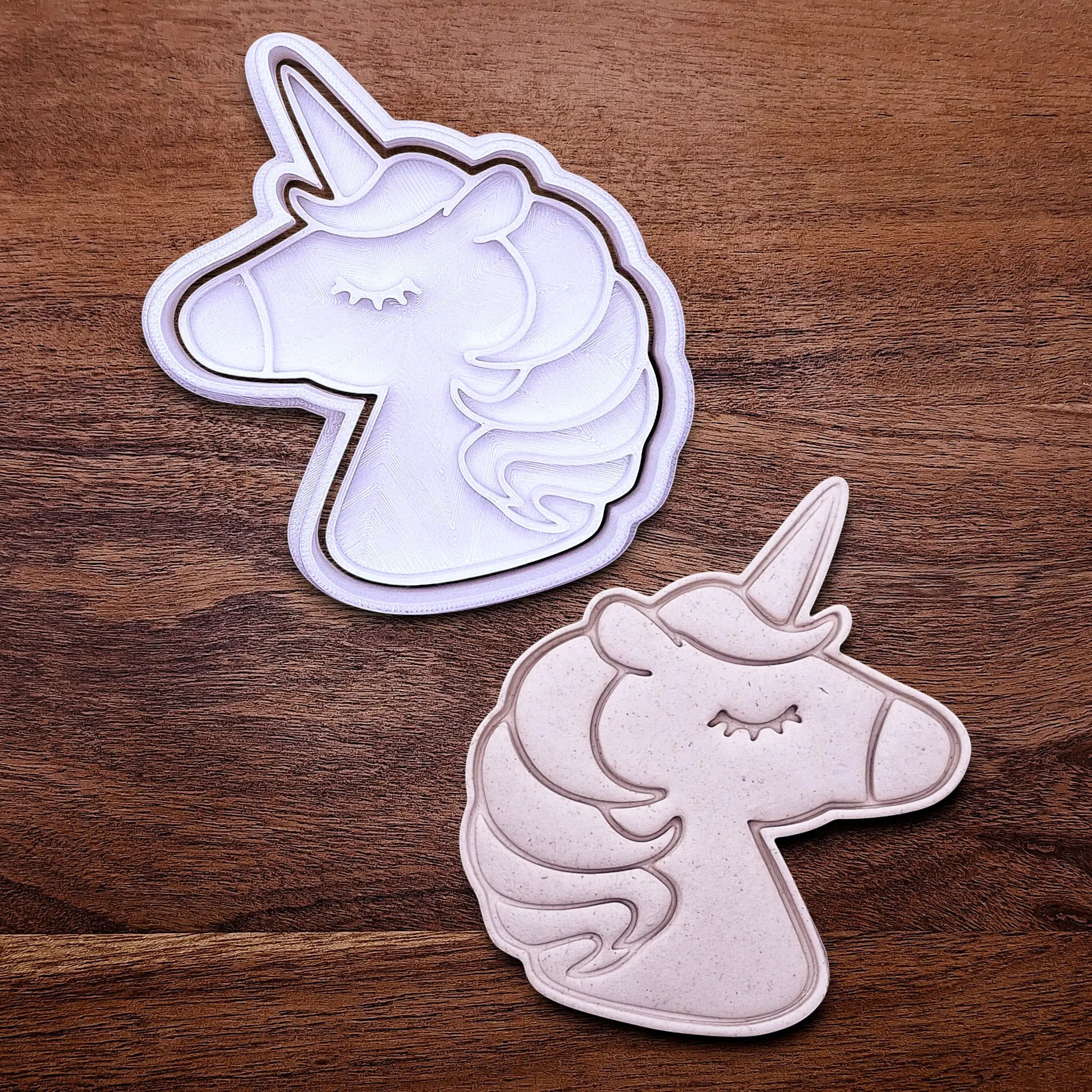 Handmade and customizable unicorn cookie cutter and stamp alongside a dough cutout and imprint, perfect for magical themed birthday parties, fondant decorating, or gifting to unicorn lovers.