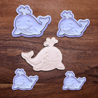 Handmade and customizable whale cookie cutters and stamps set alongside a dough cutout and imprint, ideal for making adorable aquatic and nautical cookies for baby showers, birthdays, and parties.