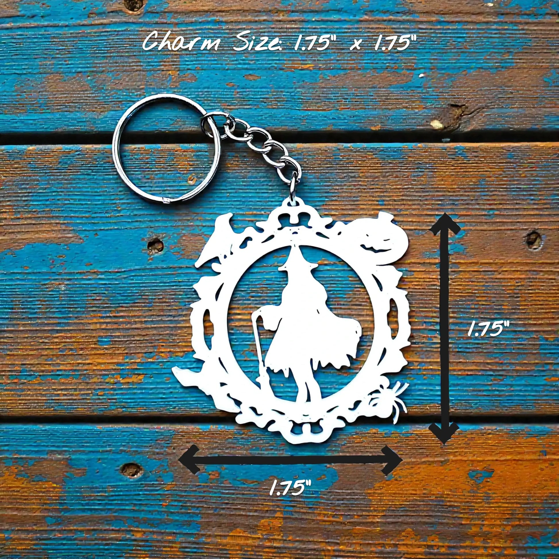 Handmade and customizable Halloween keychain in white featuring a witch, bats, crows, and pumpkins. Perfect for spooky season trick or treats, party favors and goth inspired gifts.