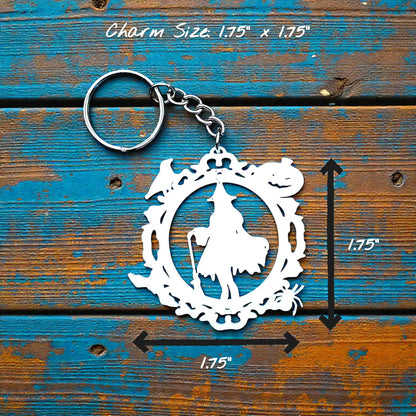 Handmade and customizable Halloween keychain in white featuring a witch, bats, crows, and pumpkins. Perfect for spooky season trick or treats, party favors and goth inspired gifts.