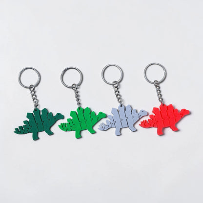 Handmade and customizable dinosaur fidget keychains in various colors, featuring colorful articulated designs, perfect for kids birthday parties, classroom prizes, sensory play, and party favor dino gifts.