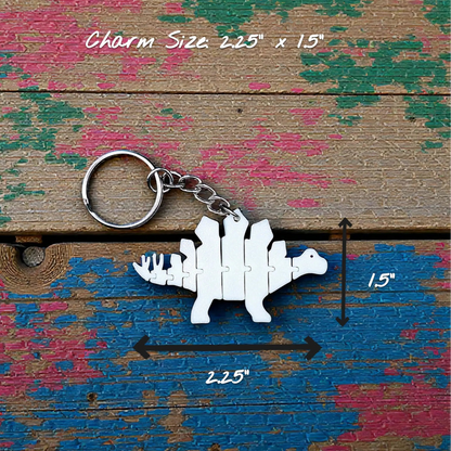 Handmade and customizable dinosaur fidget keychain in white, featuring colorful articulated designs, perfect for kids birthday parties, classroom prizes, sensory play, and party favor dino gifts.