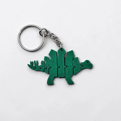 Handmade and customizable dinosaur fidget keychain, featuring colorful articulated designs, perfect for kids birthday parties, classroom prizes, sensory play, and party favor dino gifts.