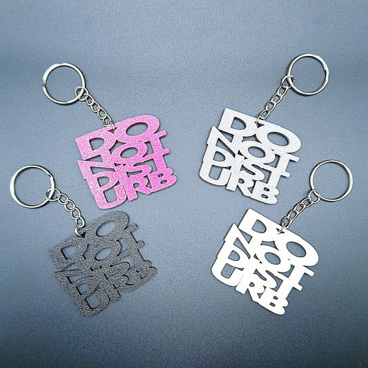 Four Do Not Disturb keychains shown in different colors, bold text design, perfect for privacy, work-from-home setups, or gamer accessories.
