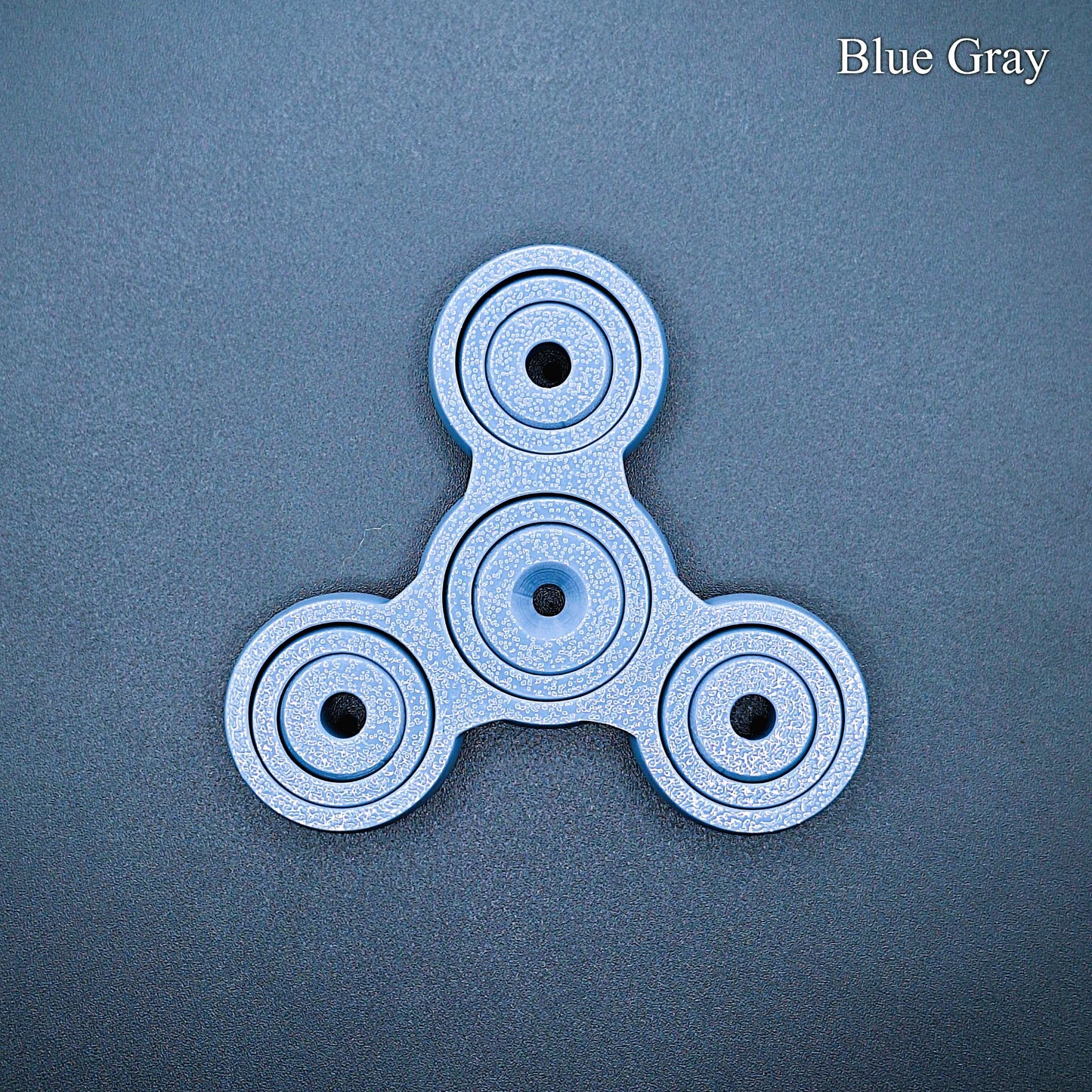 Sleek blue gray 3" pronged fidget spinner for desk, classroom, or travel use. Smooth, silent spin for focus and stress relief. Eco-friendly and handmade.