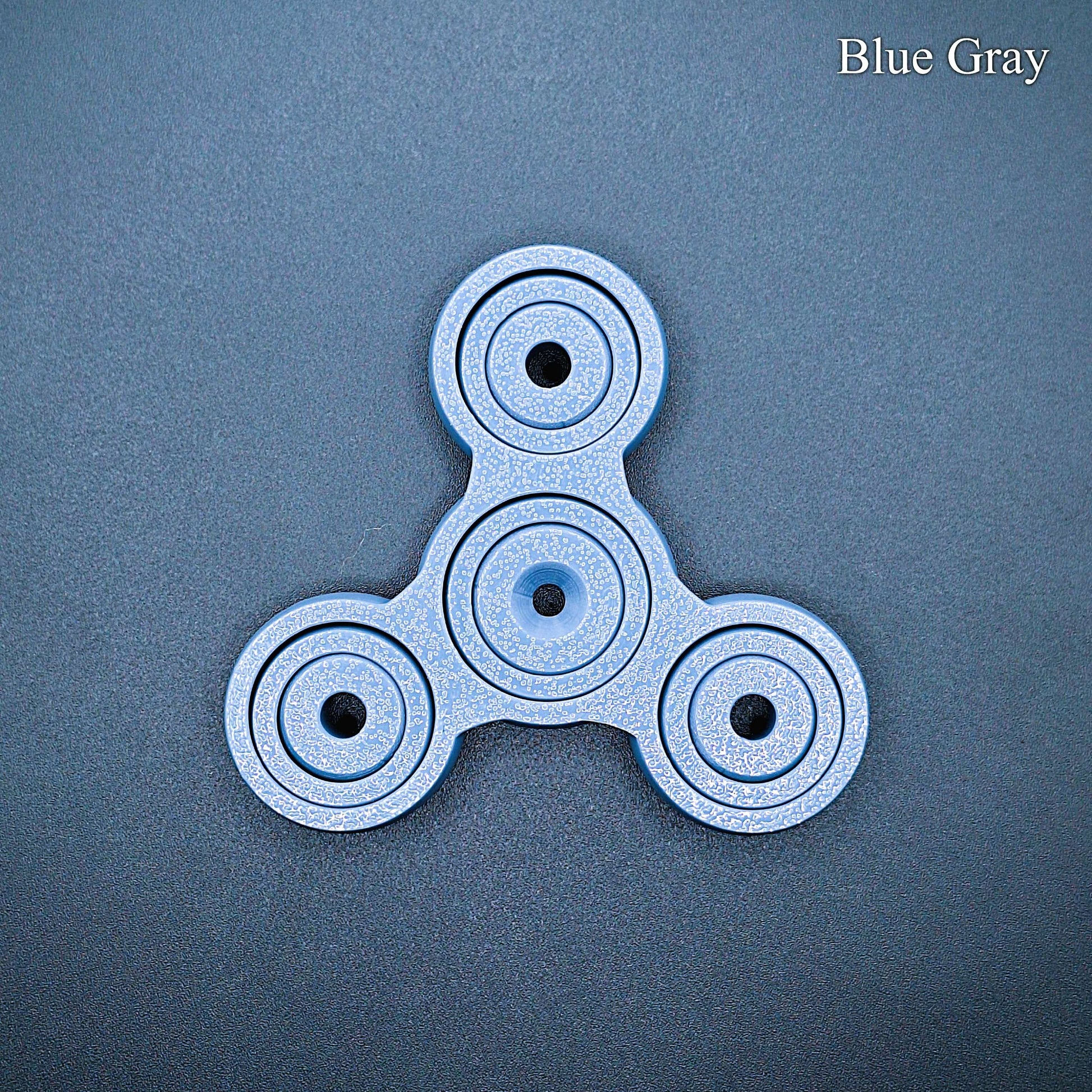 Sleek blue gray 3" pronged fidget spinner for desk, classroom, or travel use. Smooth, silent spin for focus and stress relief. Eco-friendly and handmade.