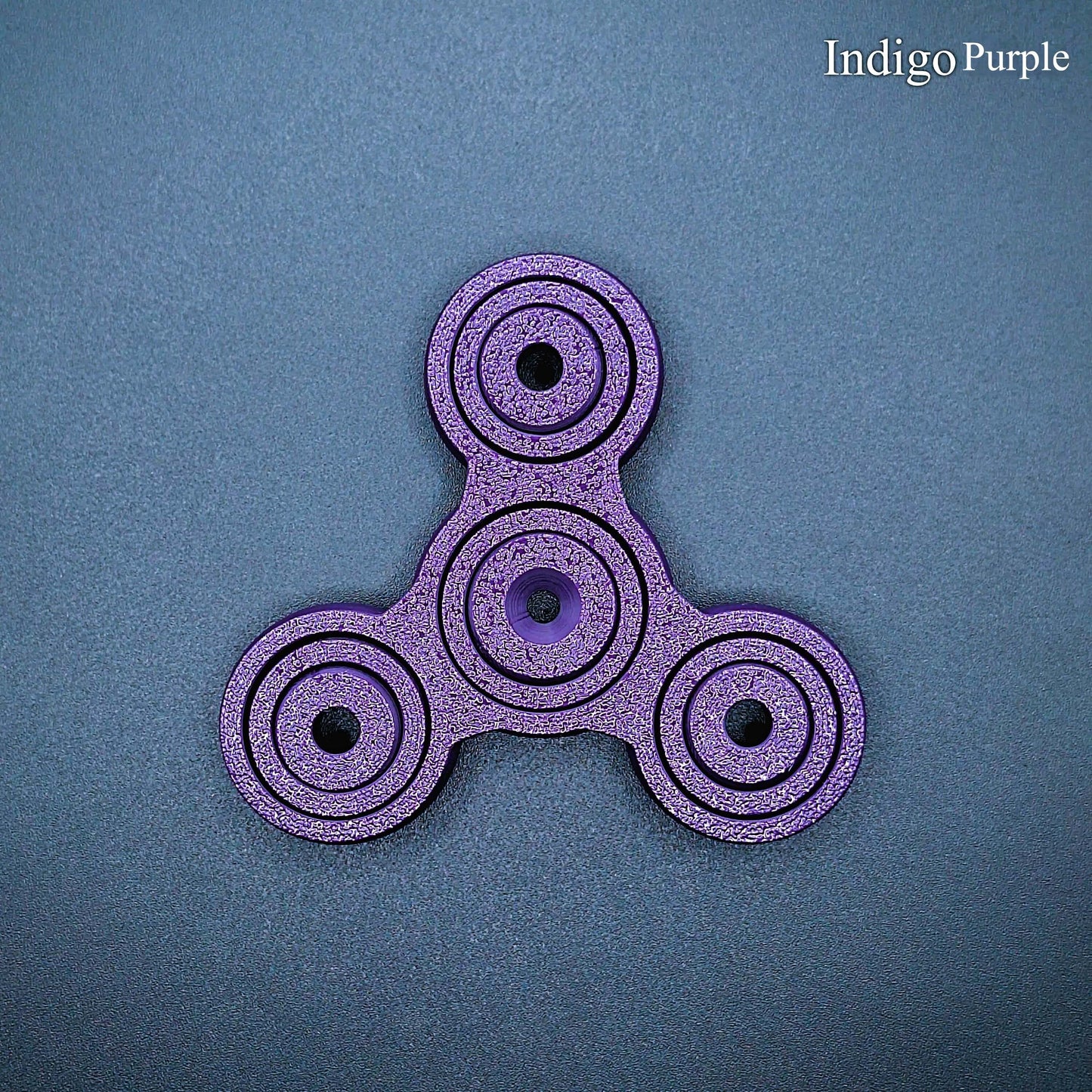 Indigo purple 3" fidget spinner with triple-prong design—perfect sensory tool for stress relief, focus, and calm. Durable, biodegradable, handmade.