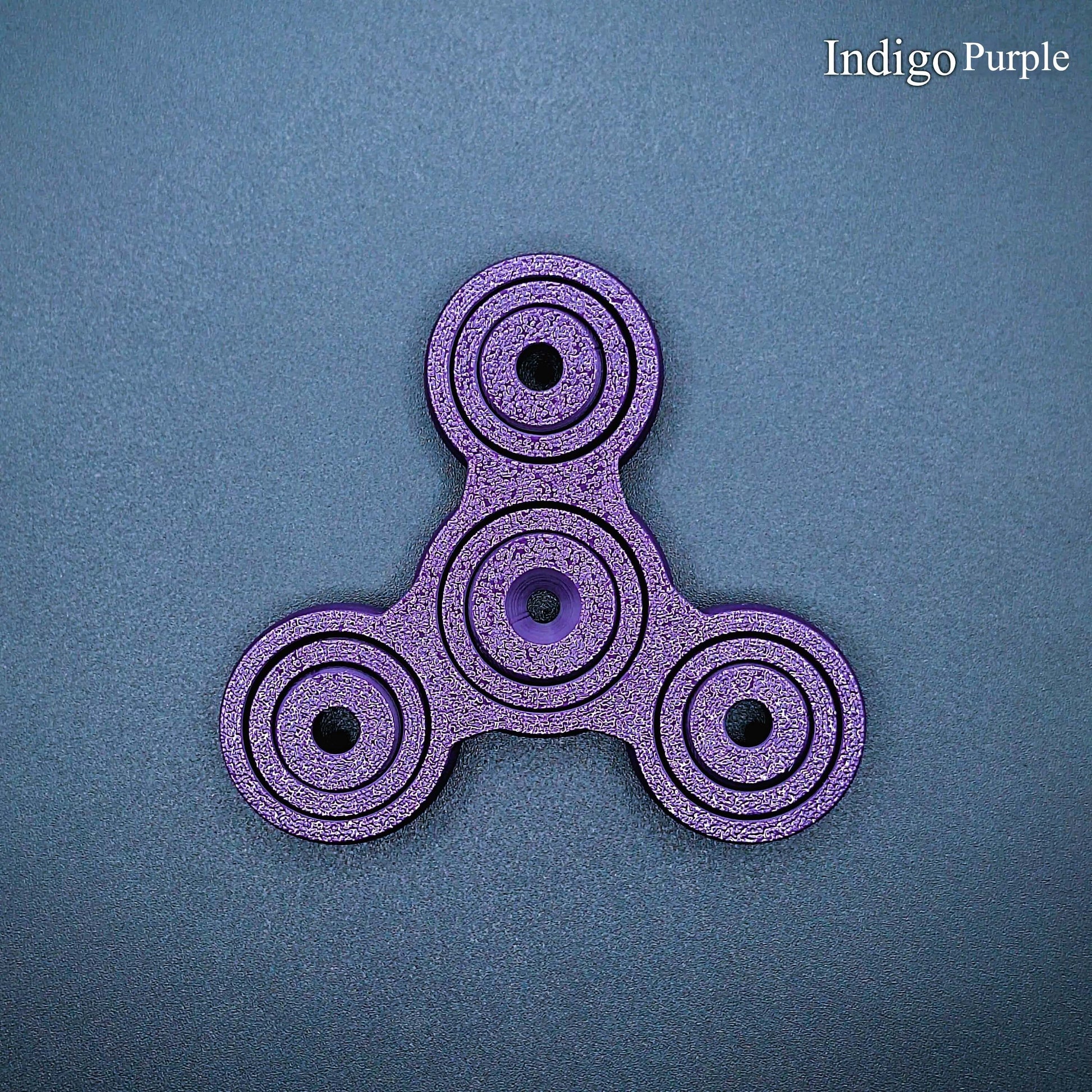 Indigo purple 3" fidget spinner with triple-prong design—perfect sensory tool for stress relief, focus, and calm. Durable, biodegradable, handmade.