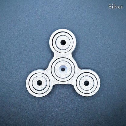 Silver 3" fidget gyro spinner with pronged design—great for anxiety, ADHD focus, and quiet sensory play. Handmade from PLA plastic.
