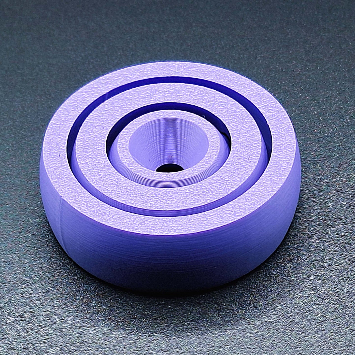 Top view of smooth-edge fidget spinner toy, designed for calming focus, handmade in the USA using sustainable, plant-based plastic.