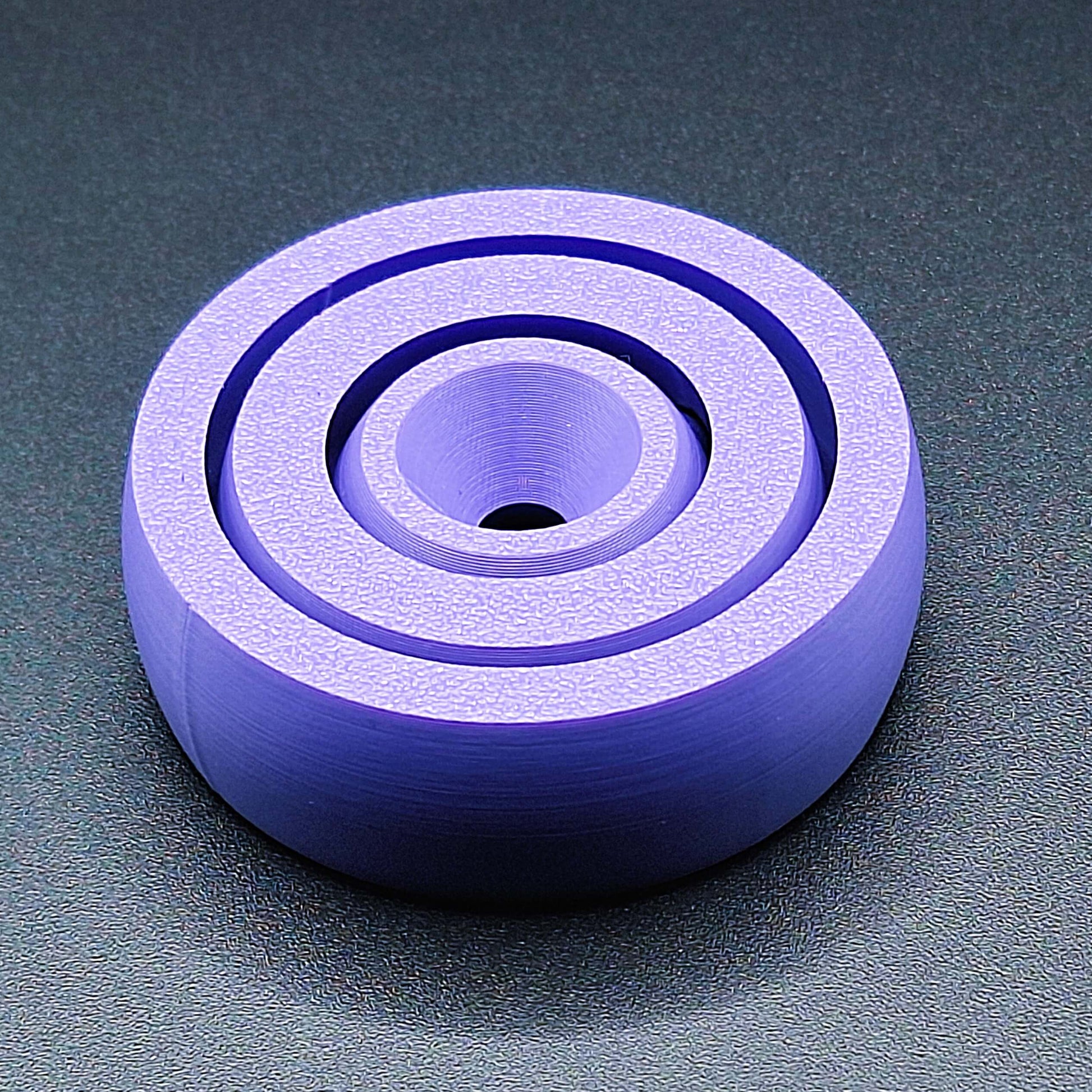Top view of smooth-edge fidget spinner toy, designed for calming focus, handmade in the USA using sustainable, plant-based plastic.