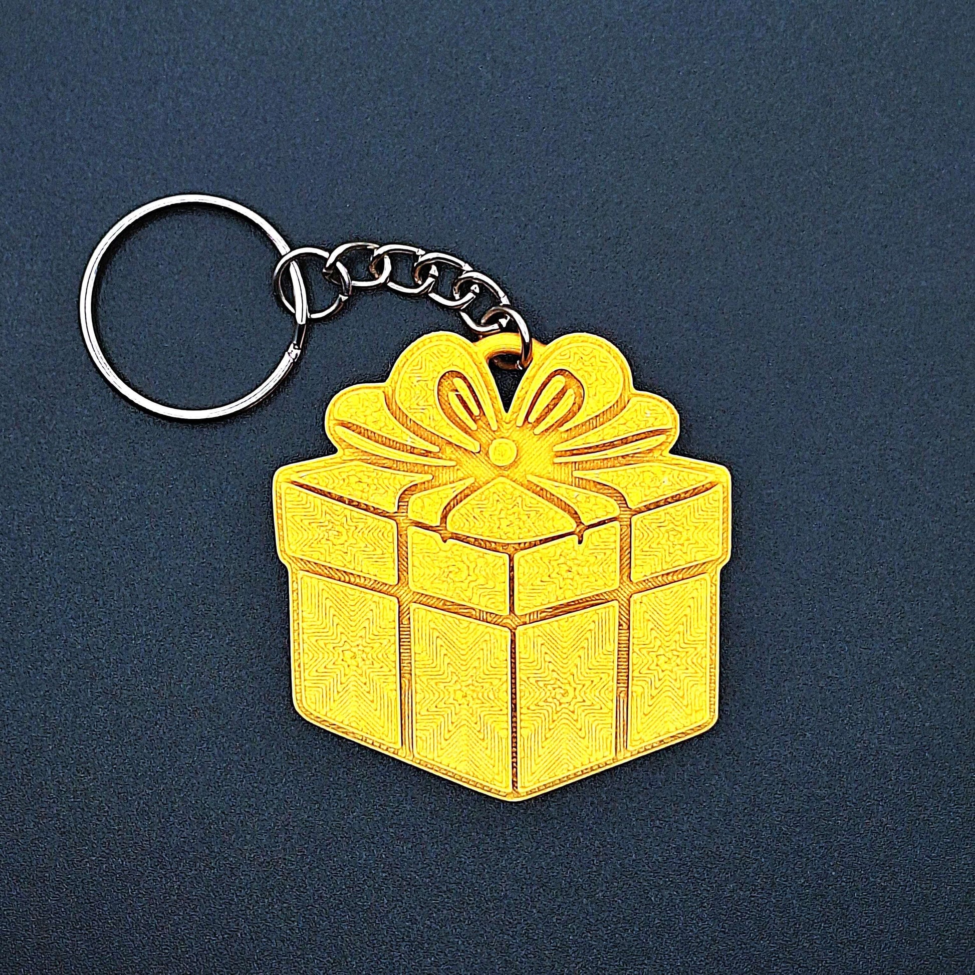 Gold gift box keychain—shiny, festive charm made from eco PLA plastic; great for Christmas gifts, birthday favors, or stylish bag accessories.