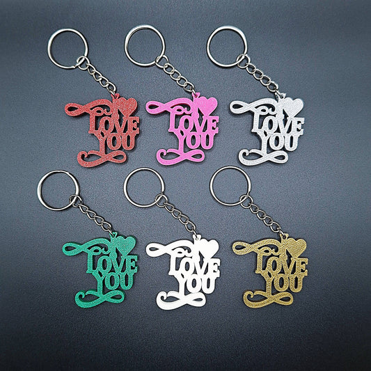 Six I Love You keychains in assorted vibrant colors, handmade from biodegradable PLA, perfect for romantic gifts or sweet everyday accessories.