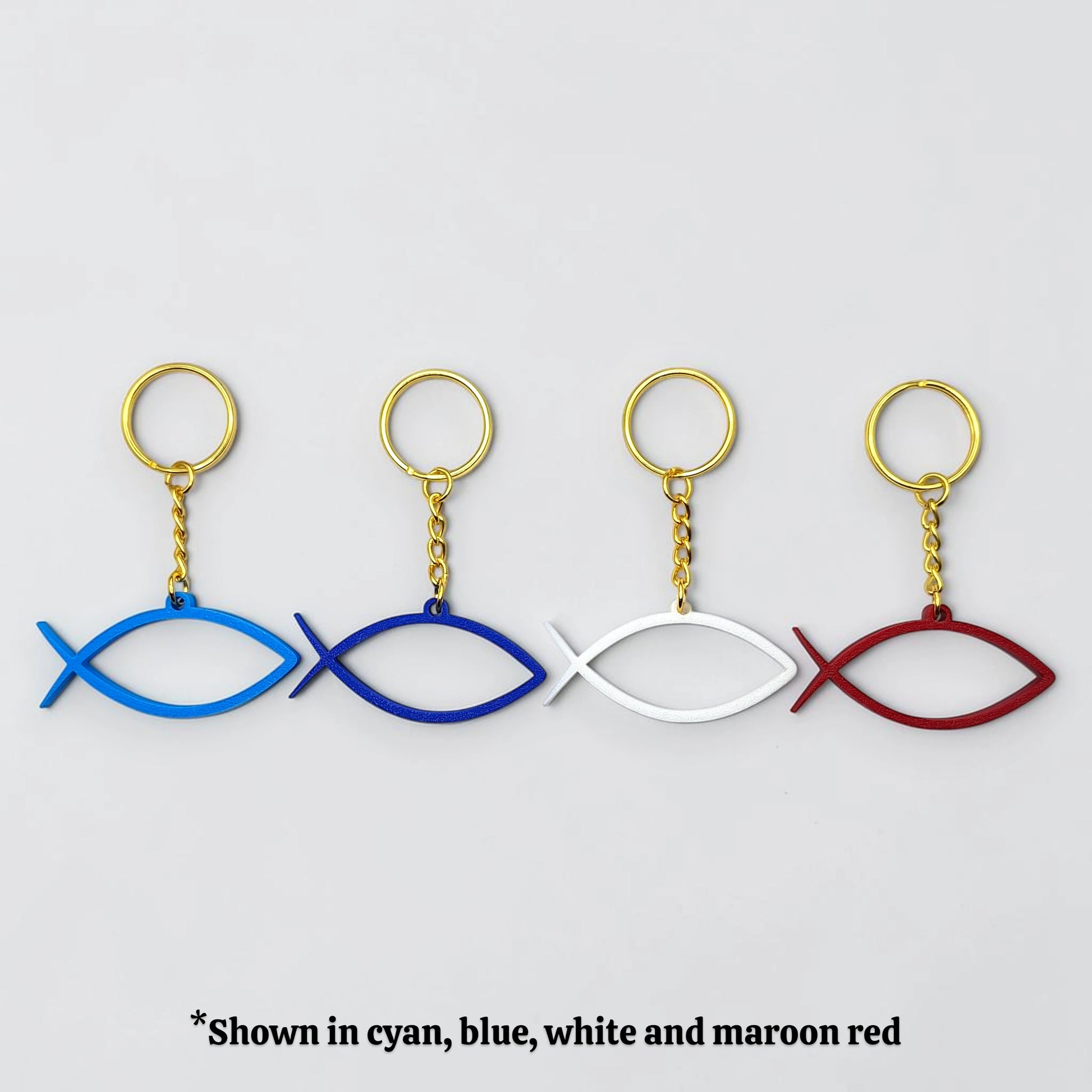 Handmade and customizable Ichthys Fish Keychains in four colors with gold keyrings, inspirational religious charms for Easter gifts, VBS giveaways, and church favors.