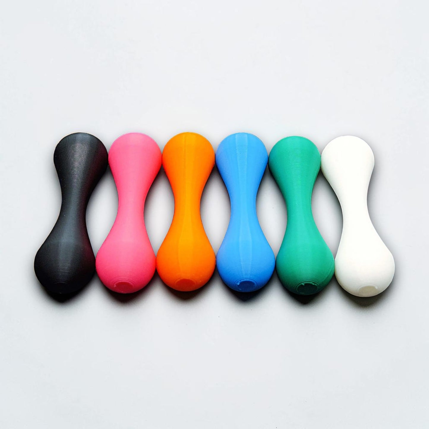 Top-down view of six knucklebone fidget skill toys made from eco-friendly PLA, great for focus, flipping tricks, and mindful fidgeting.