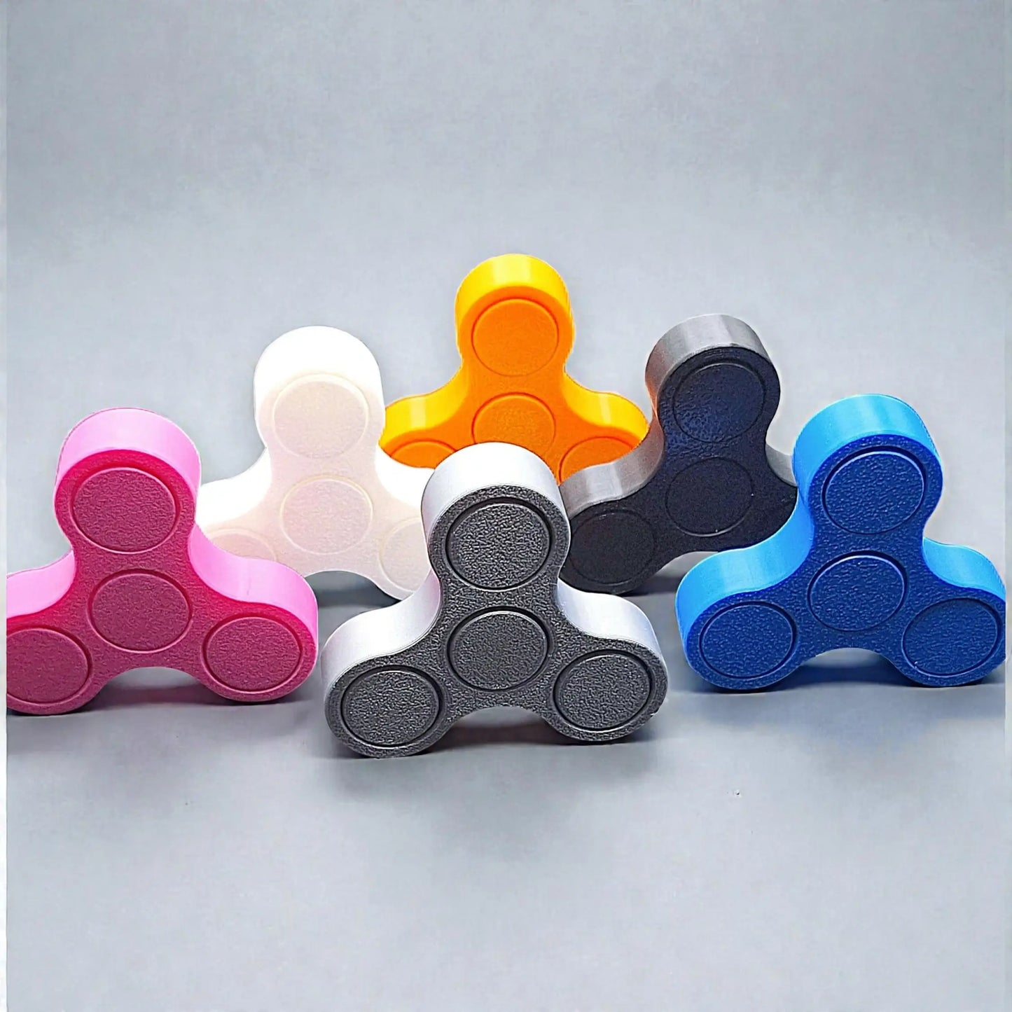 Handmade and customizable mini fidget spinners in vibrant colors and ideal for quiet, stress-relieving play, anxiety relief and focus.