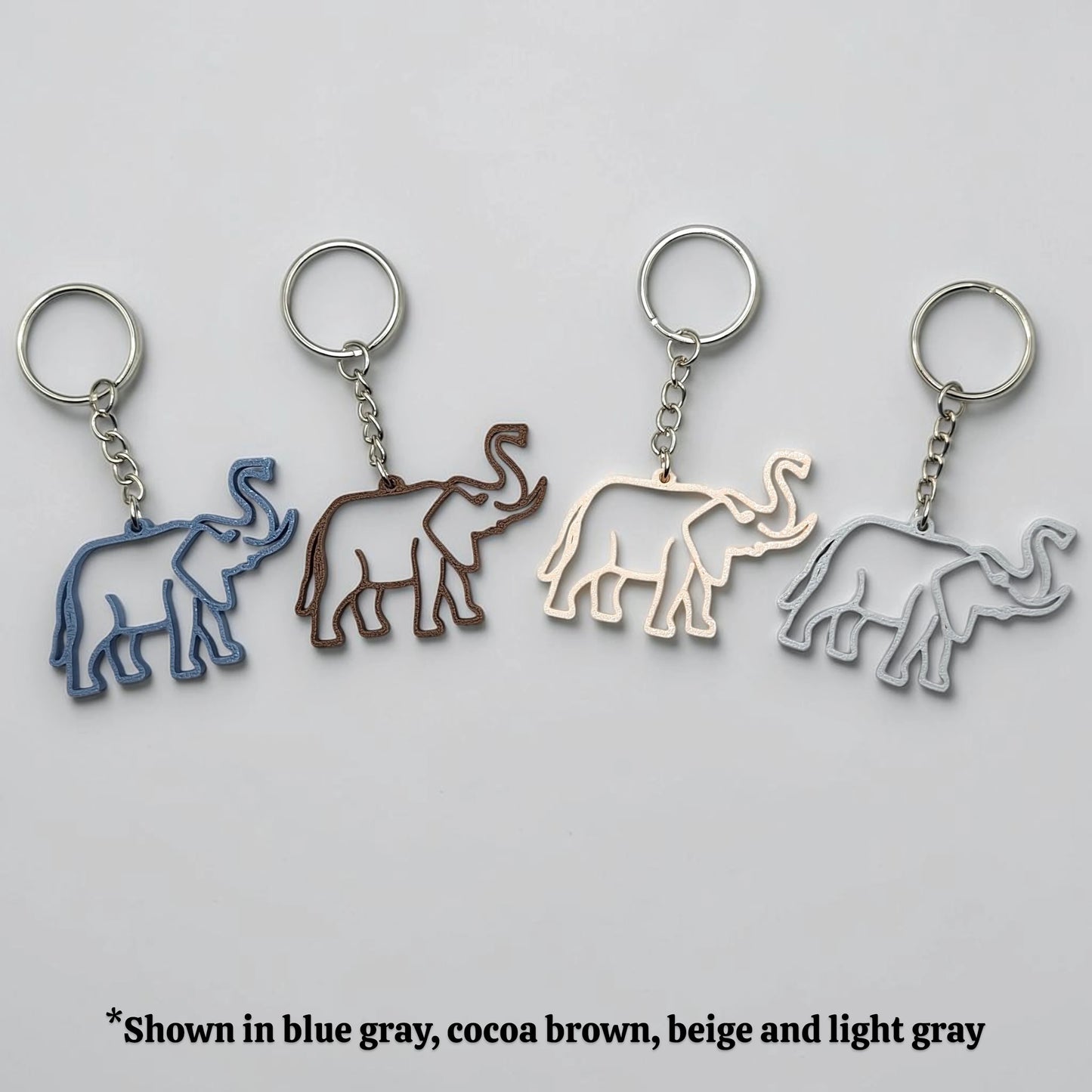 Safari elephant keychains in various colors with silver keyrings, perfect for classroom prizes, party favors for kids birthdays, baby showers and unique stocking stuffers.