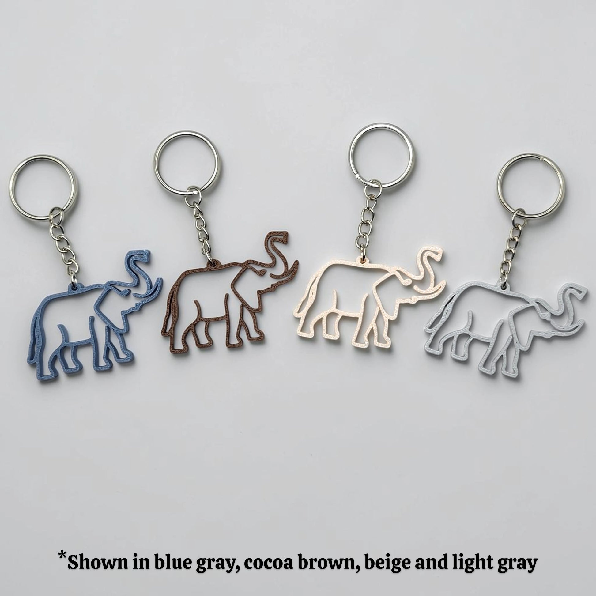 Safari elephant keychains in various colors with silver keyrings, perfect for classroom prizes, party favors for kids birthdays, baby showers and unique stocking stuffers.