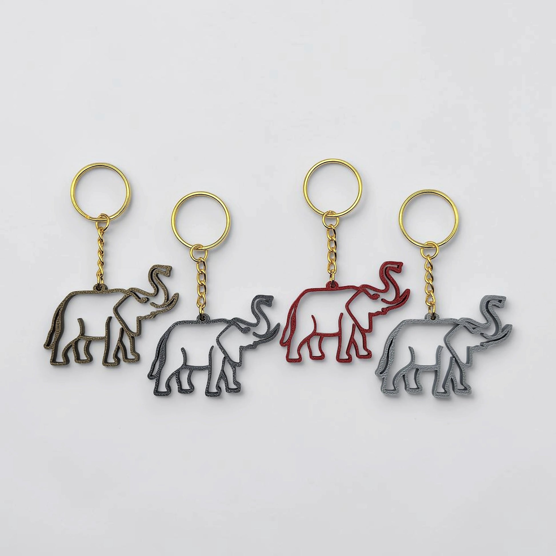 Safari elephant keychains in various colors with gold keyring, perfect for classroom prizes, party favors for kids birthdays, baby showers and unique stocking stuffers.