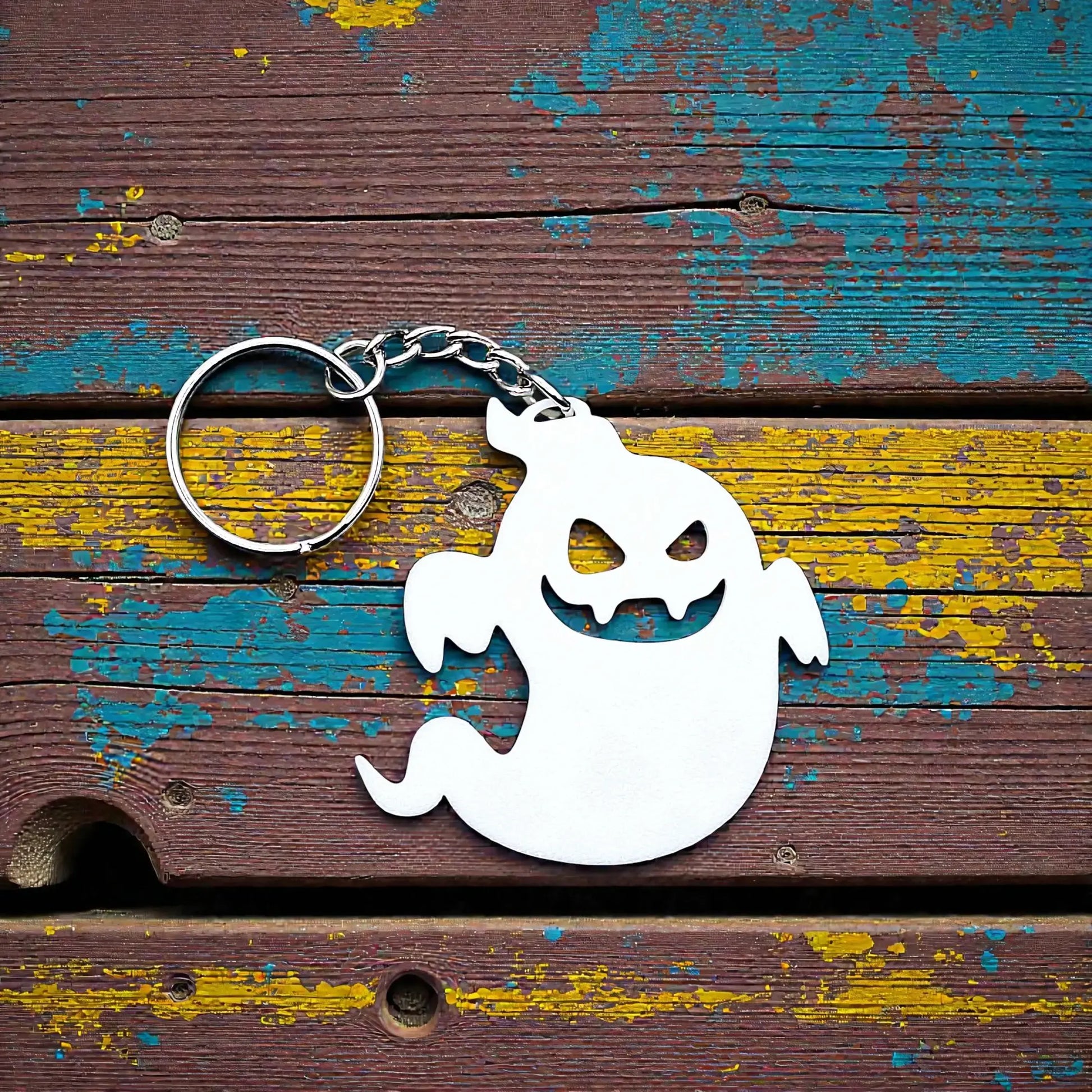 Handmade spooky Halloween ghost keychain in white, ideal for fall party favors, gifting, or accessorizing Halloween-themed trick or treat bags or keys.