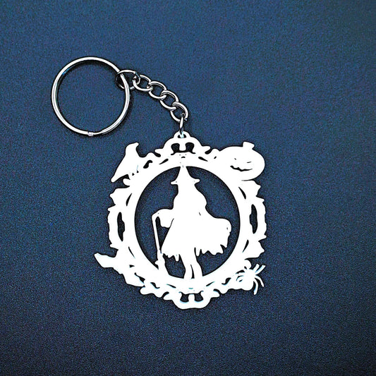 Spooky witch keychain charm with festive Halloween border of pumpkin, bat, crow, and spider, handmade accessory for keyrings and bags.