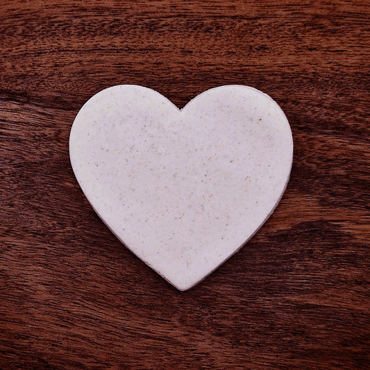 Heart-shaped cookie or dough cutout with a smiley face stamp, perfect for baking, fondant, or DIY crafts.