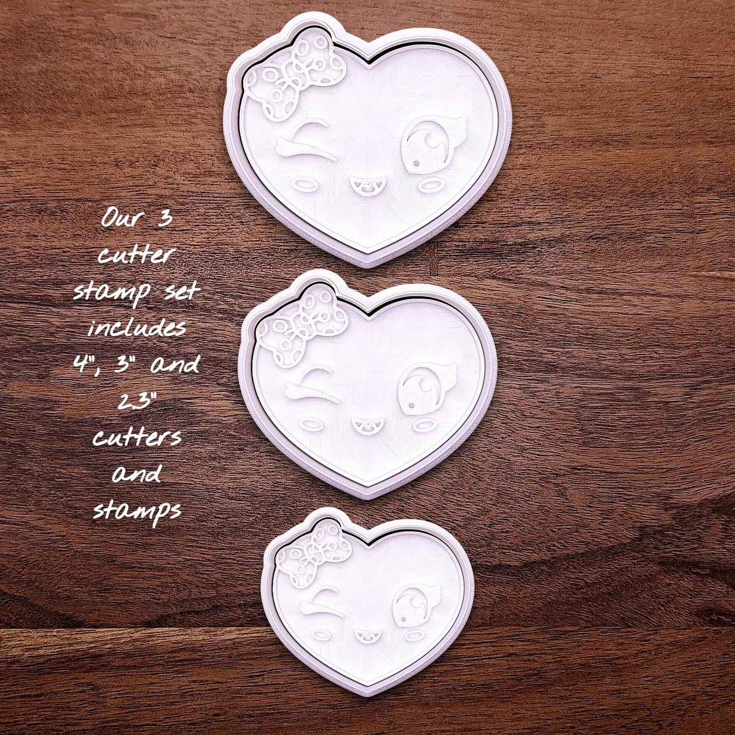 Heart cookie cutter set with matching stamps — features cute winking face and bow design for sweet custom cookies.