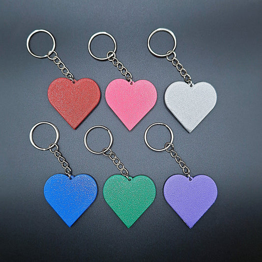 Heart keychains in six colors displayed side by side, showcasing custom color options for gifts, bag charms, and Valentine’s Day accessories.