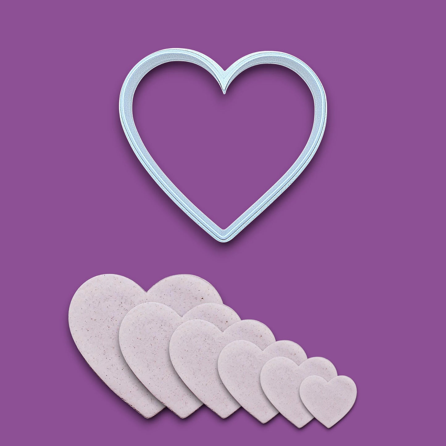 Heart cookie cutter alongside dough cutouts, perfect for layered cookies, fondant, crafts, weddings, and Valentine’s Day baking fun.