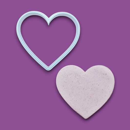 Heart cookie cutter alongside a dough cutout. Perfect for layered cookies, fondant, crafts, weddings, and Valentine’s Day baking fun.