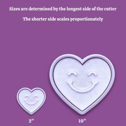 Handmade and customizable heart cookie cutter with cute face stamp alongside a size scale from 2" to 10".