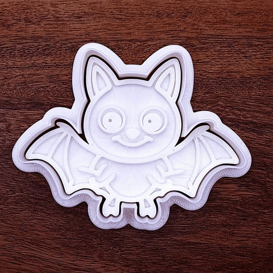 Close-up of bat cookie cutter with matching stamp, perfect for spooky Halloween cookies, fondant crafts, and gothic-themed baking projects.