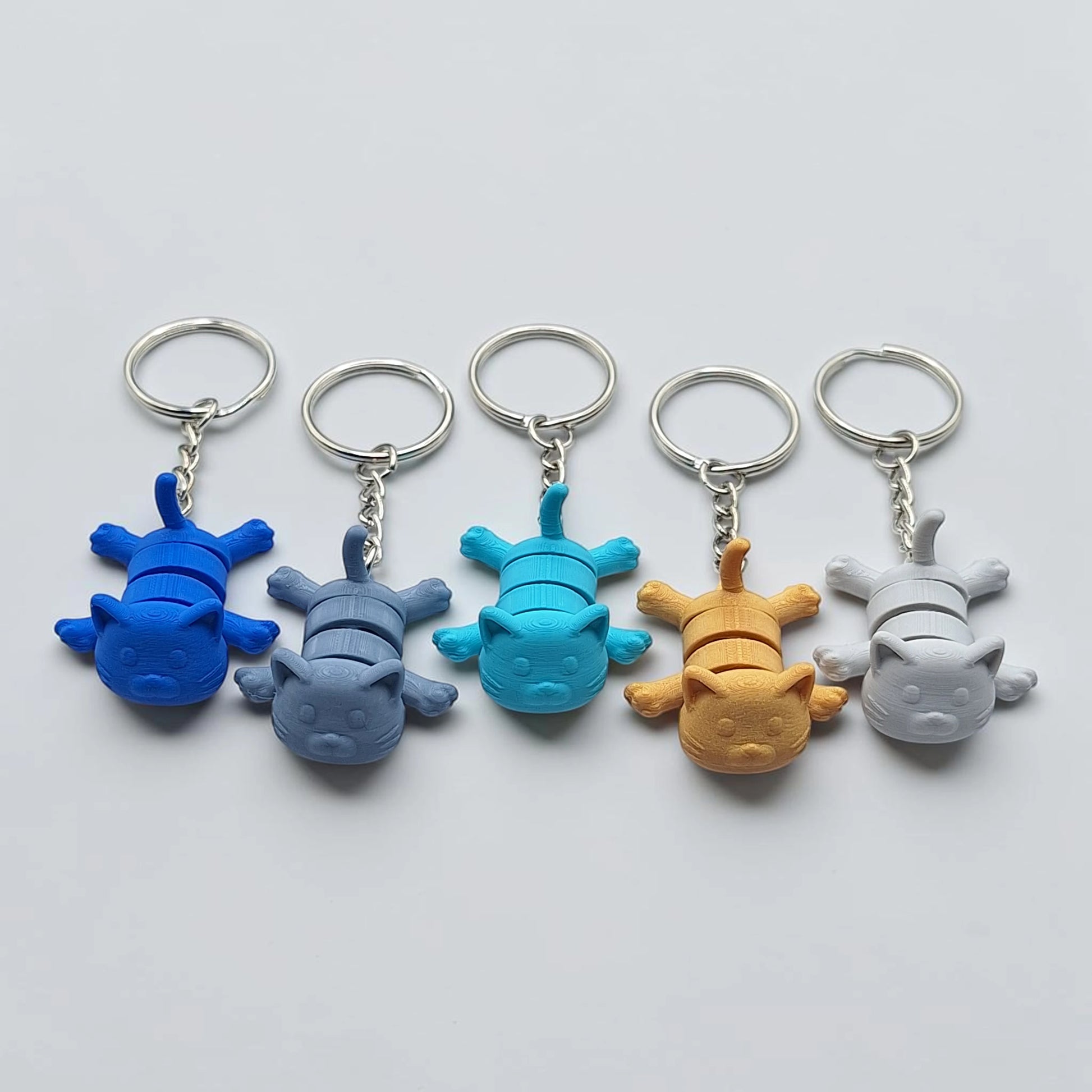 Articulated cat keychains, customizable and handmade, perfect for classroom prizes, party favors and event giveaways.
