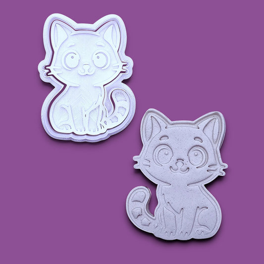 Customizable cat cookie cutter and stamp alongside a cat dough cutout and imprint, perfect for kitty cookie designs, fondant toppers, birthday parties, crafts or cat themed baking projects.