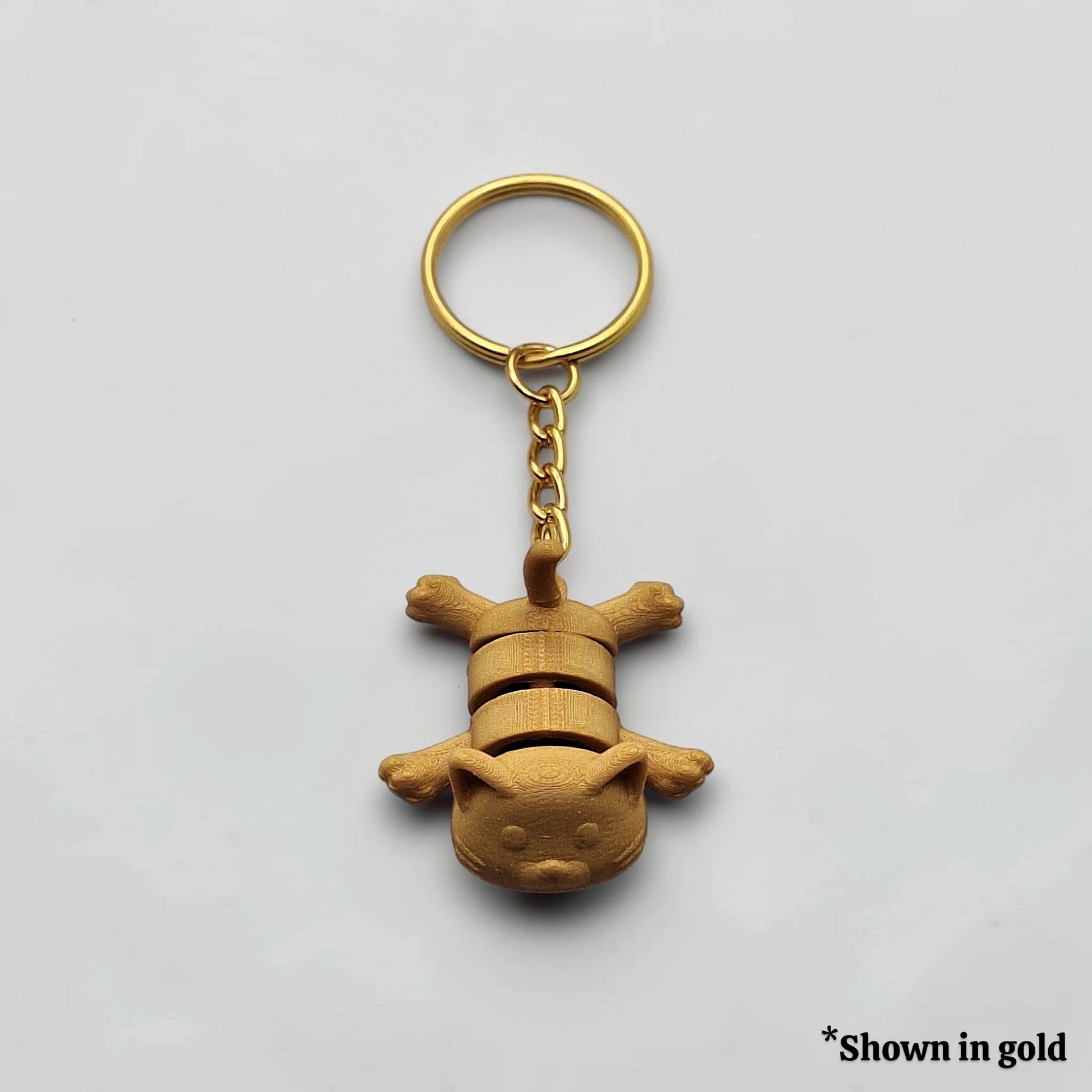 Articulated cat keychain in gold, customizable and handmade, perfect for classroom prizes, party favors and event giveaways.