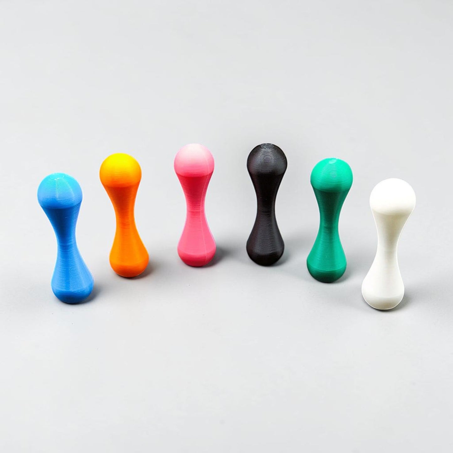 Knucklebone fidget toys in multiple colors, perfect for flipping, rolling, and improving hand coordination and stress relief.