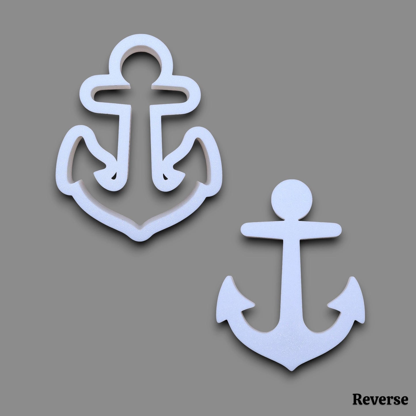 Two white anchor-shaped cutters shown on a plain gray background, labeled 'Reverse' in the bottom right corner.