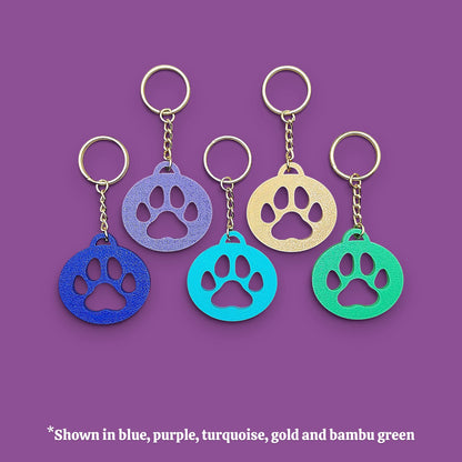 Paw print keychain with silver keyrings, perfect for dog moms, cat lovers, rescue volunteers, shelter giveaways, and vet clinics. Handmade and customizable in 30 unique colors.