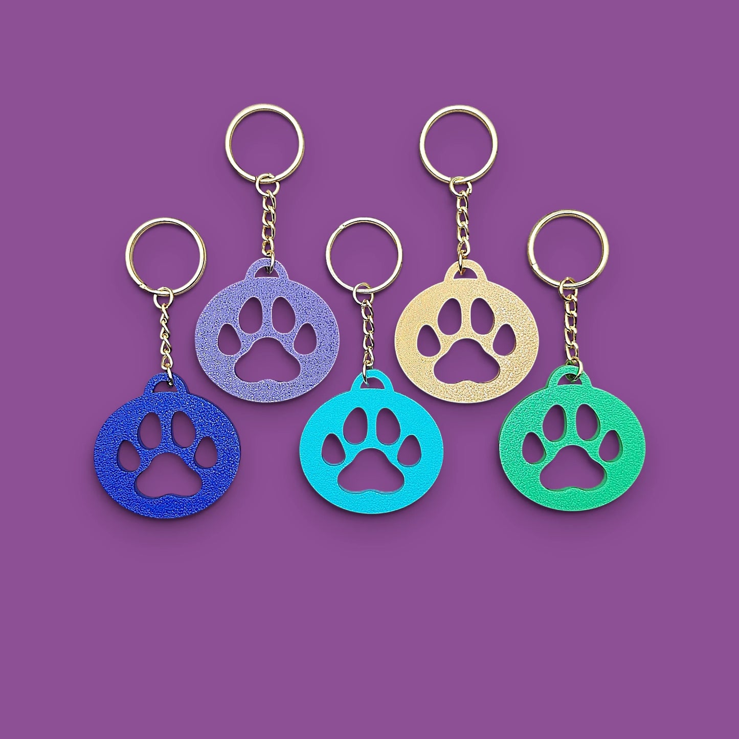 Paw print keychains, perfect for dog moms, cat lovers, rescue volunteers, shelter giveaways, and vet clinics. Handmade and customizable in 30 unique colors.