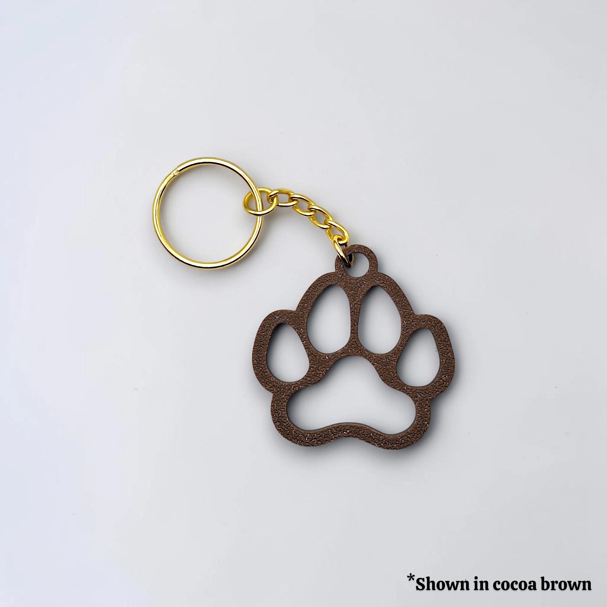 Handmade and customizable paw keychain in cocoa brown, ideal for honoring pets, gifting to animal lovers, or everyday use.